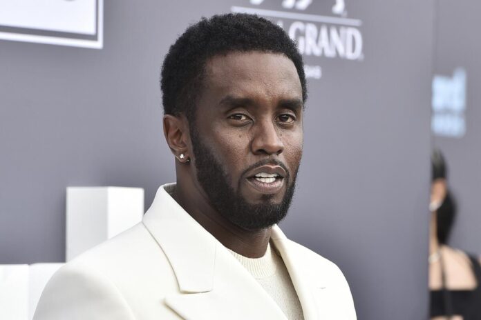 Diddy wearing white suit