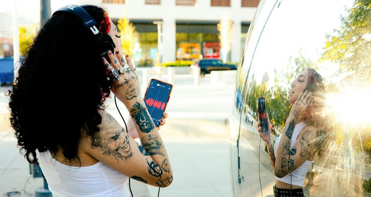 Tattooed woman checking her smartphone