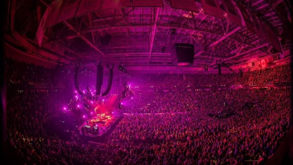 Crowd at concert with stage lighting