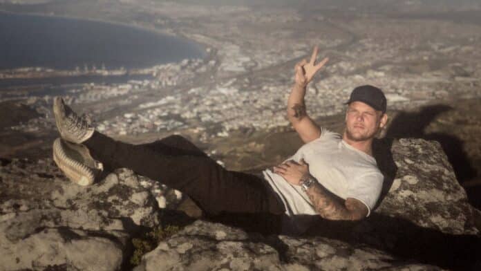 Avicii reclines on mountain rocks