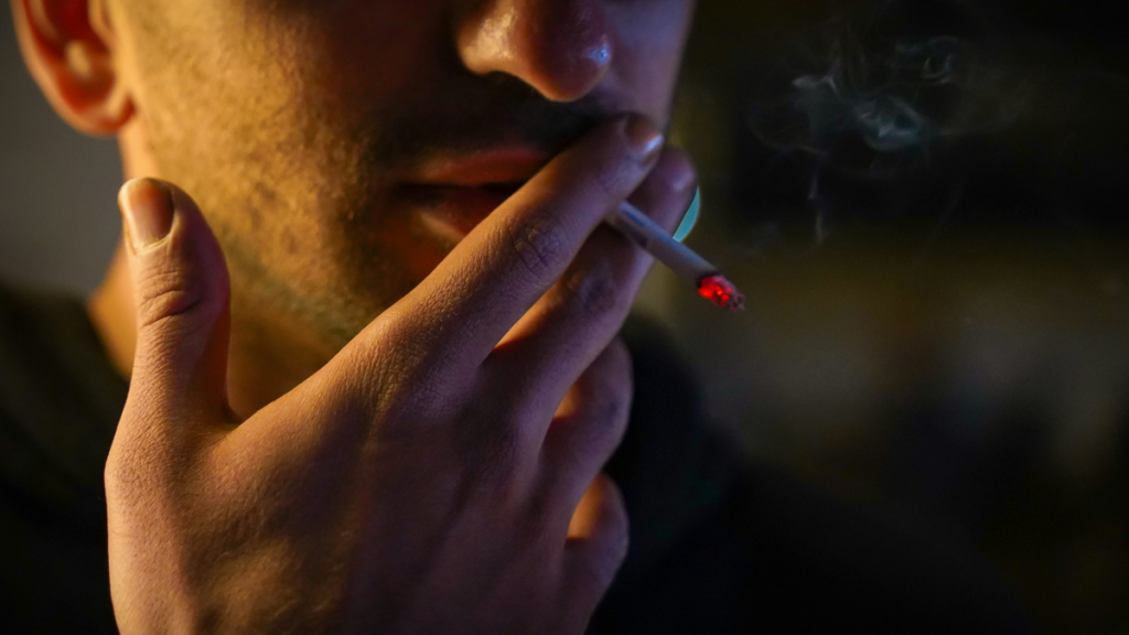 Man smoking in British pub