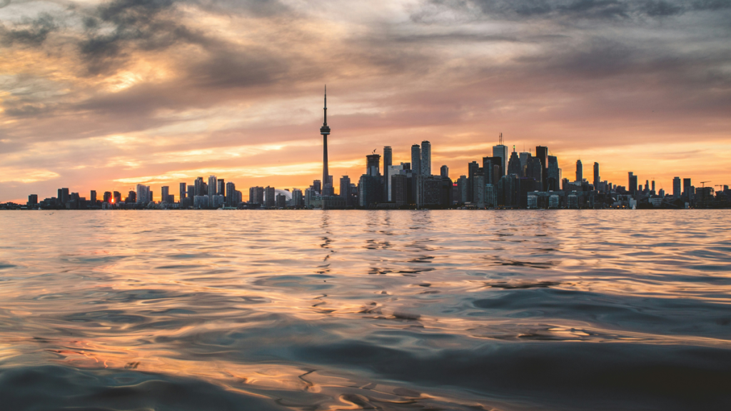 Toronto skyline at sunset over lake