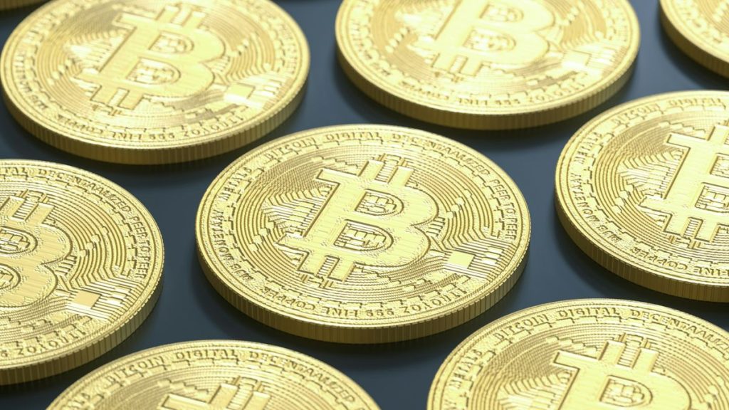 Defocused gold Bitcoin coins on surface