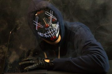 Hooded hacker in dark clothing