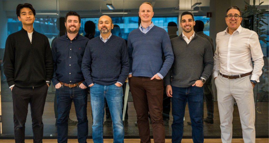 Six trolley board employees standing together