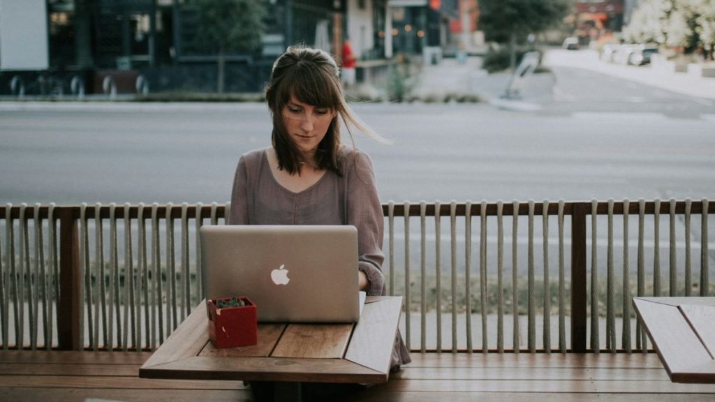 Woman using laptop outdoors