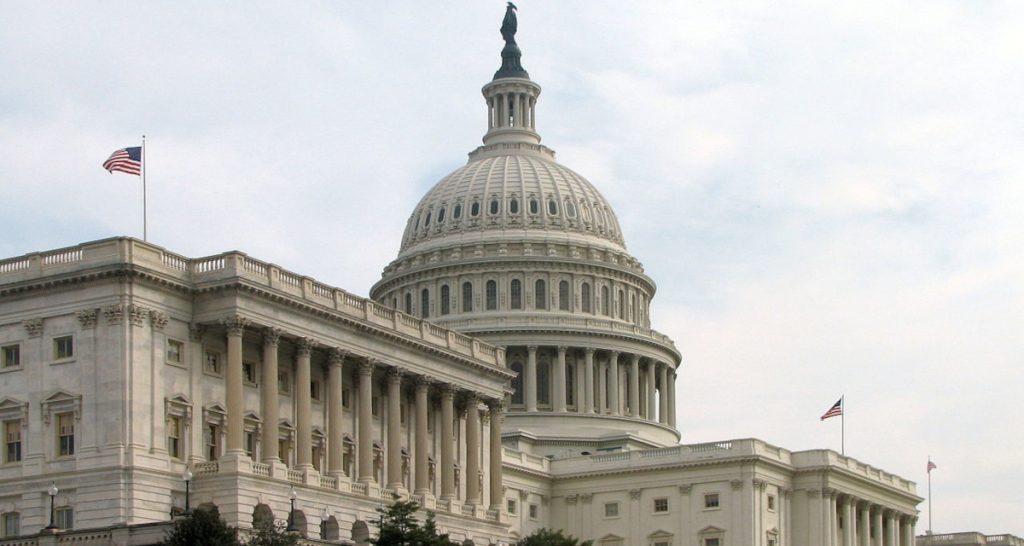 US Capitol dome with American flags