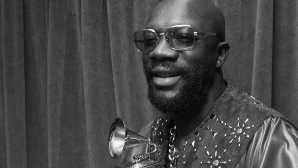 Isaac Hayes smiling with trumpet