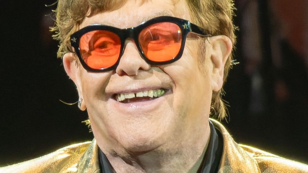 Elton John wearing tinted medical glasses