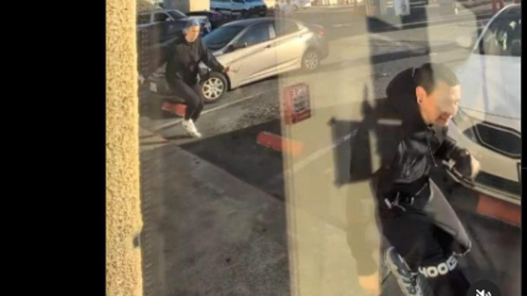 Man wearing black hoodie, looking distressed