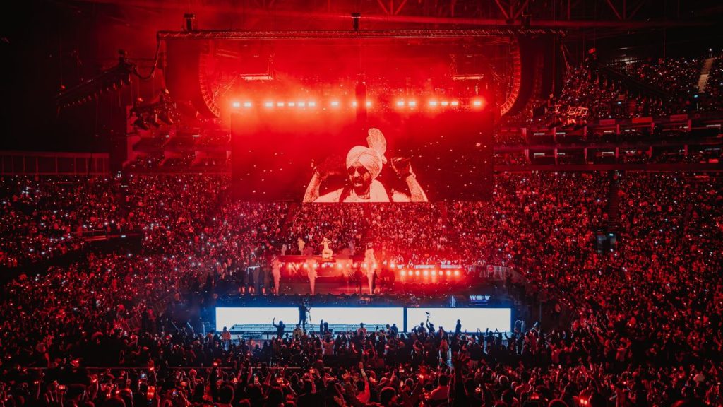 Concert crowd under red lighting