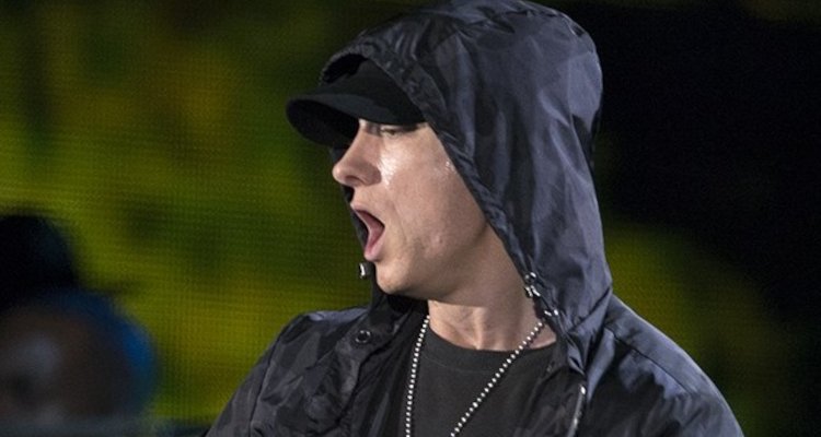 Eminem in black jacket and cap