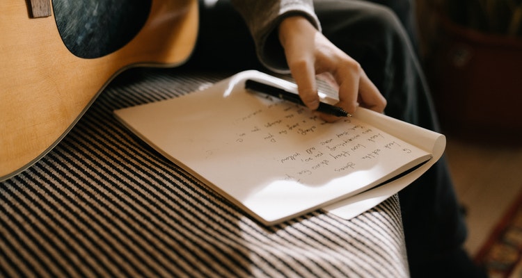 Songwriter composing at desk