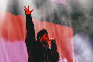 The Weeknd performing with upraised arm