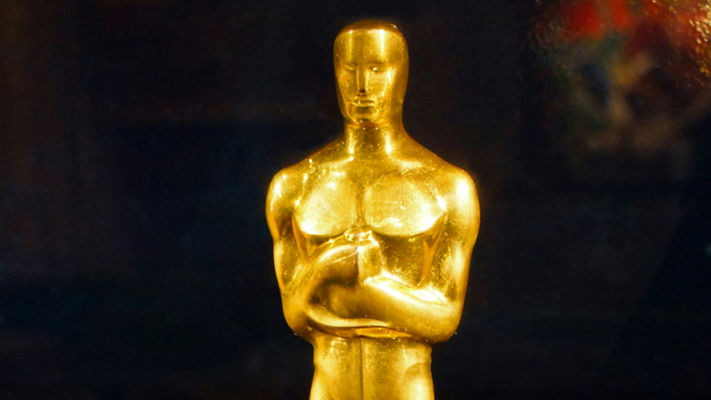 Golden Oscar statuette against dark background