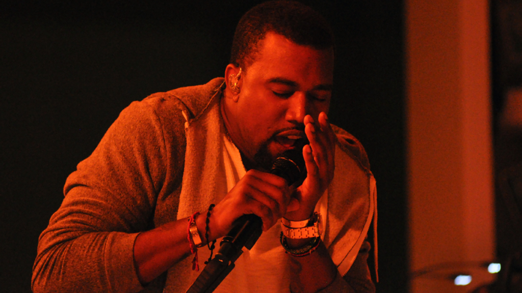 Kanye West performs with mic