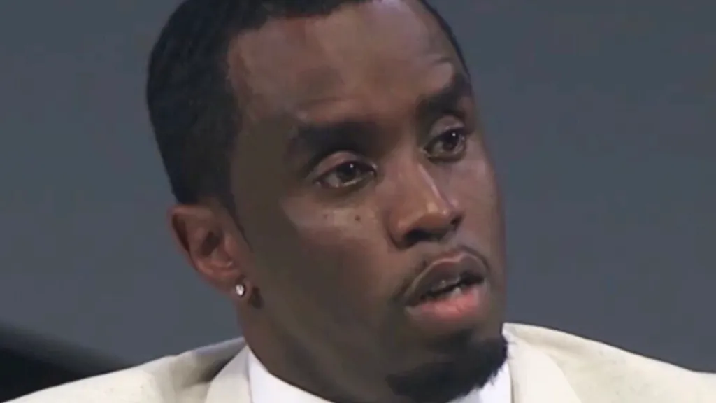 Diddy wearing white suit NBC lawsuit