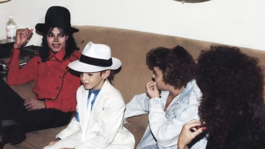 Michael Jackson flanked by alleged victims