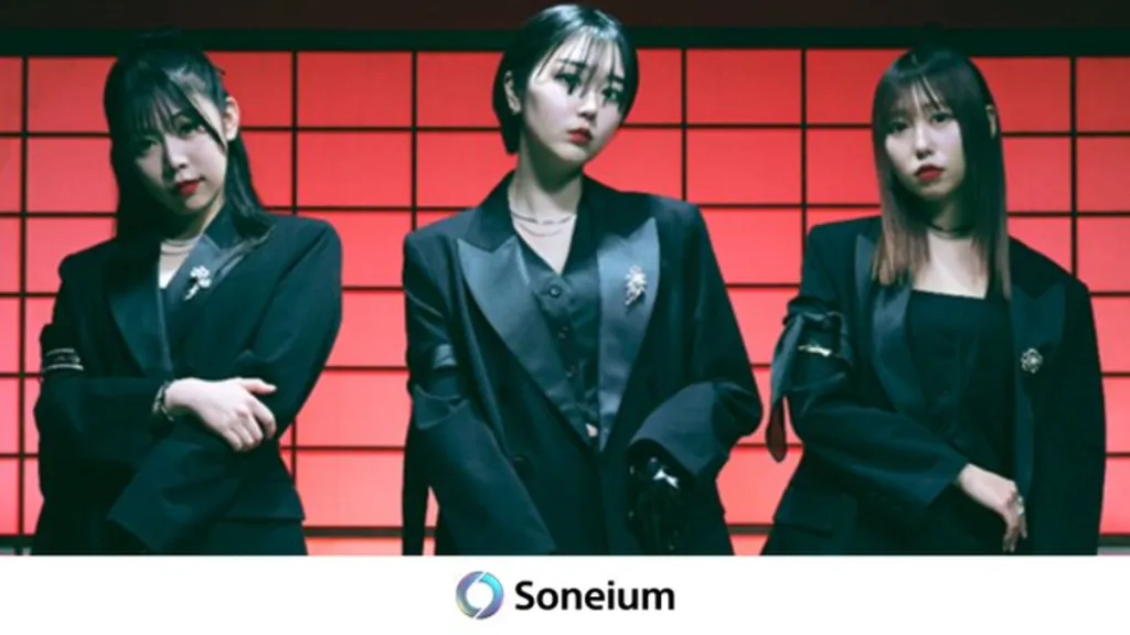 Three J-pop performers in black suits